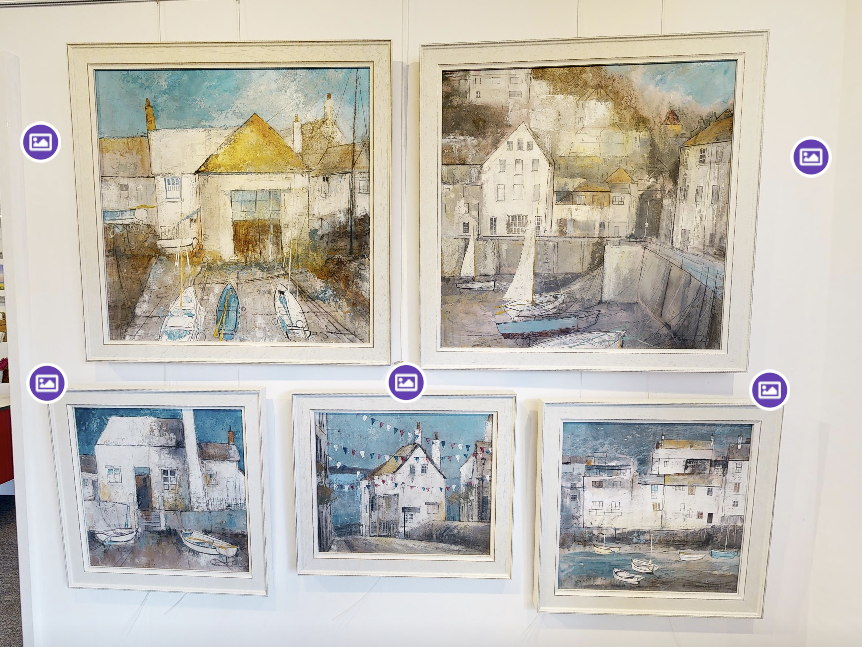 Coastal paintings displayed in a gallery with interactive artwork tags