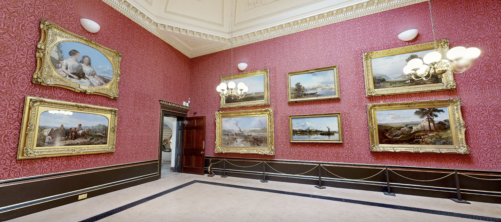Museum exhibition room with framed paintings, ornate red walls and display lighting
